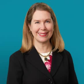 Professional headshot of Rebecca J. Paessun, MD in black blazer against teal background
