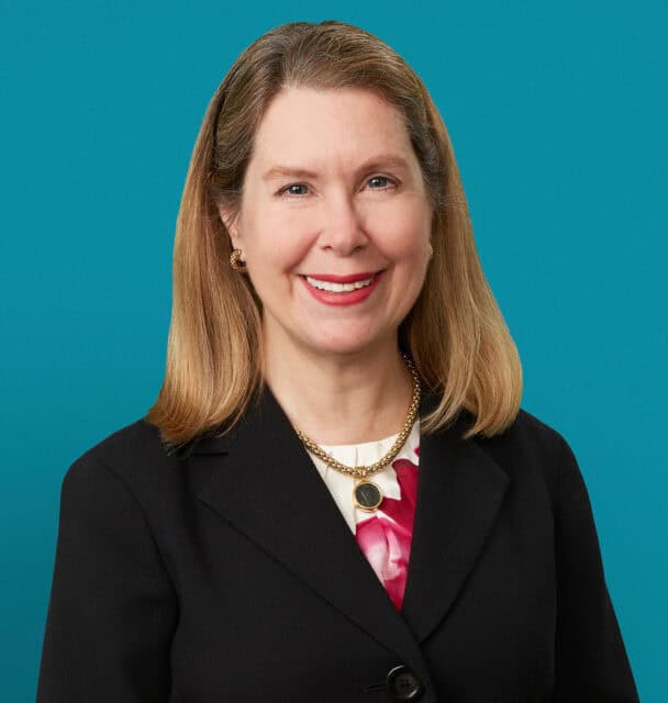 Professional headshot of Rebecca J. Paessun, MD in black blazer against teal background
