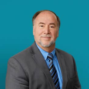 Professional headshot of Richard K. Smith, DO in gray suit with blue striped tie