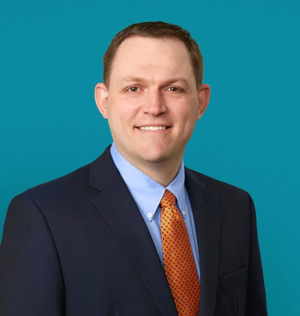 Professional headshot of Scott R. Day, PA-C in navy suit with orange patterned tie