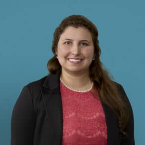 Professional headshot of Shaher-Baano Haider, MD in business attire against blue background