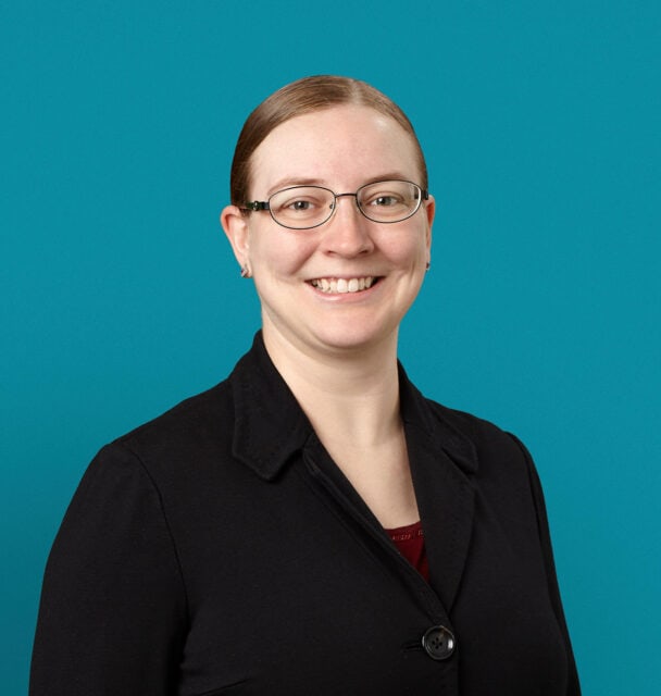 Professional headshot of Dr. Stefanie K. Lewis wearing glasses and black blazer