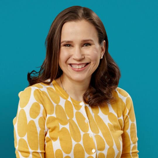 Professional headshot of Dr. Suzanne L. Bell smiling in yellow patterned cardigan