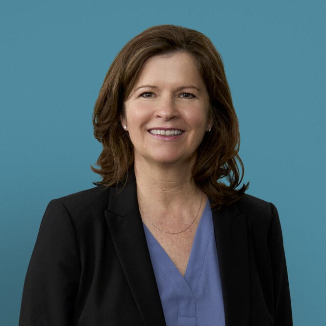 Professional headshot of Tiffany D. Williams, APRN-CNP, smiling in business attire against blue background.