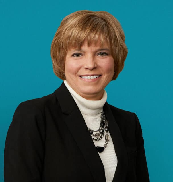 Professional headshot of Tracy S. Coy, PA-C in black blazer and white turtleneck