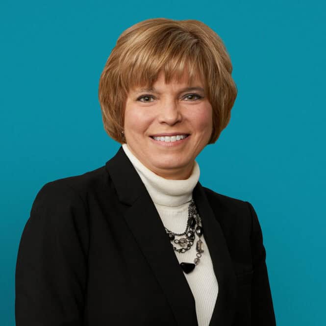 Professional headshot of Tracy S. Coy, PA-C in black blazer and white turtleneck