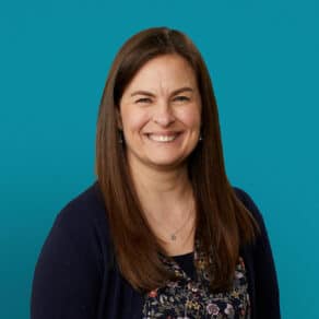 Professional headshot of Vanessa Wehrley, APRN-CNP, smiling in navy cardigan against teal background