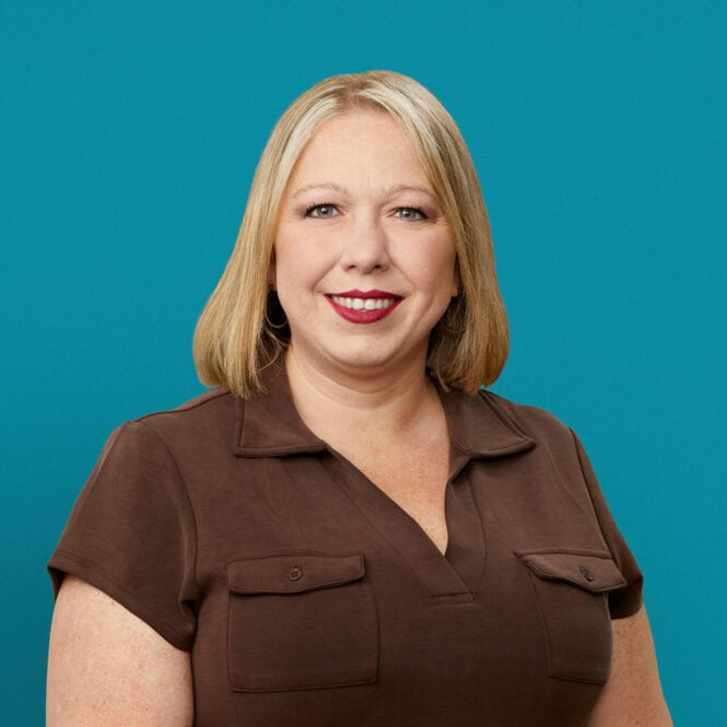 Professional headshot of Wendy Fields, APRN-CNP, smiling in brown shirt against teal background.