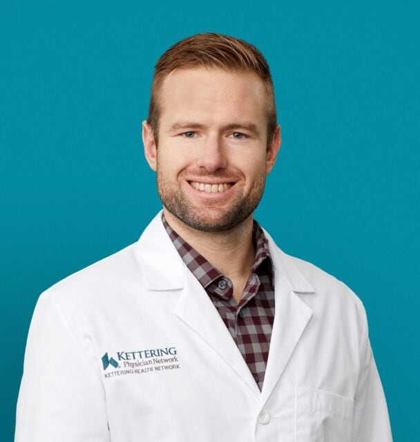 Professional headshot of William T. Allnutt, APRN-CNP in white Kettering Health coat