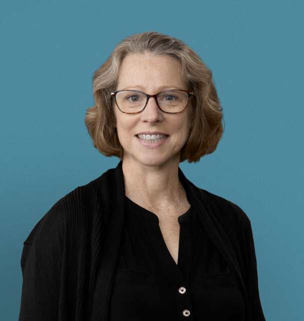Professional headshot of Dr. Melissa E. Hanna wearing glasses and black cardigan