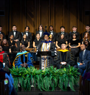 Dr. Mitchell speaking at a podium