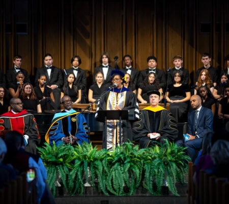Dr. Mitchell speaking at a podium