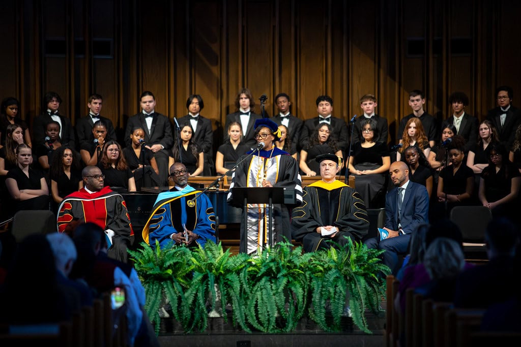 Dr. Mitchell speaking at a podium
